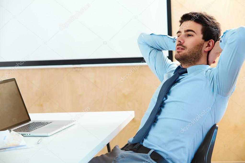 Businessman sitting in a bright office