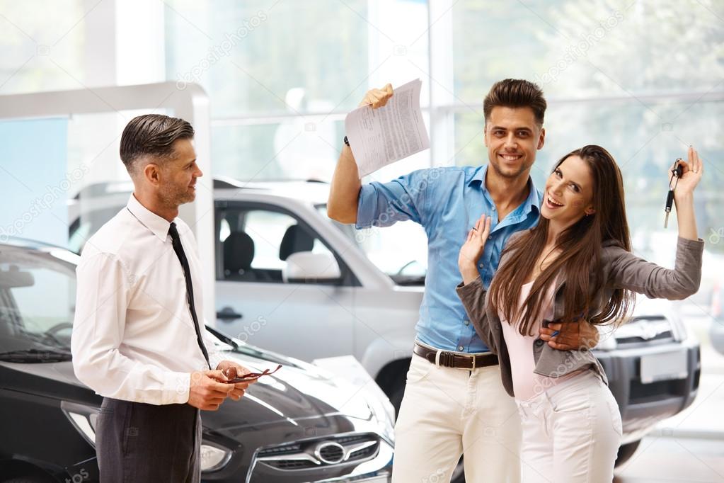 Car Salesman Invites Customers at Showroom.