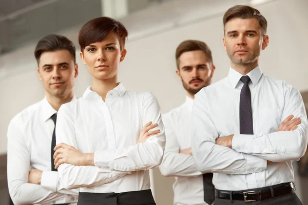 Business people standing with folded hands — Stock Photo, Image