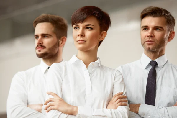 Business people standing with folded hands — Stock Photo, Image