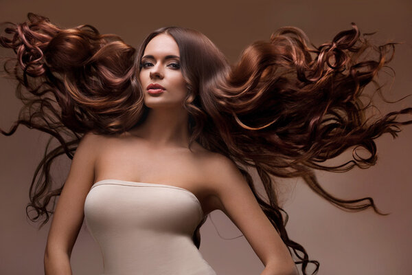 Portrait of Beautiful Woman with Long flying Hair.