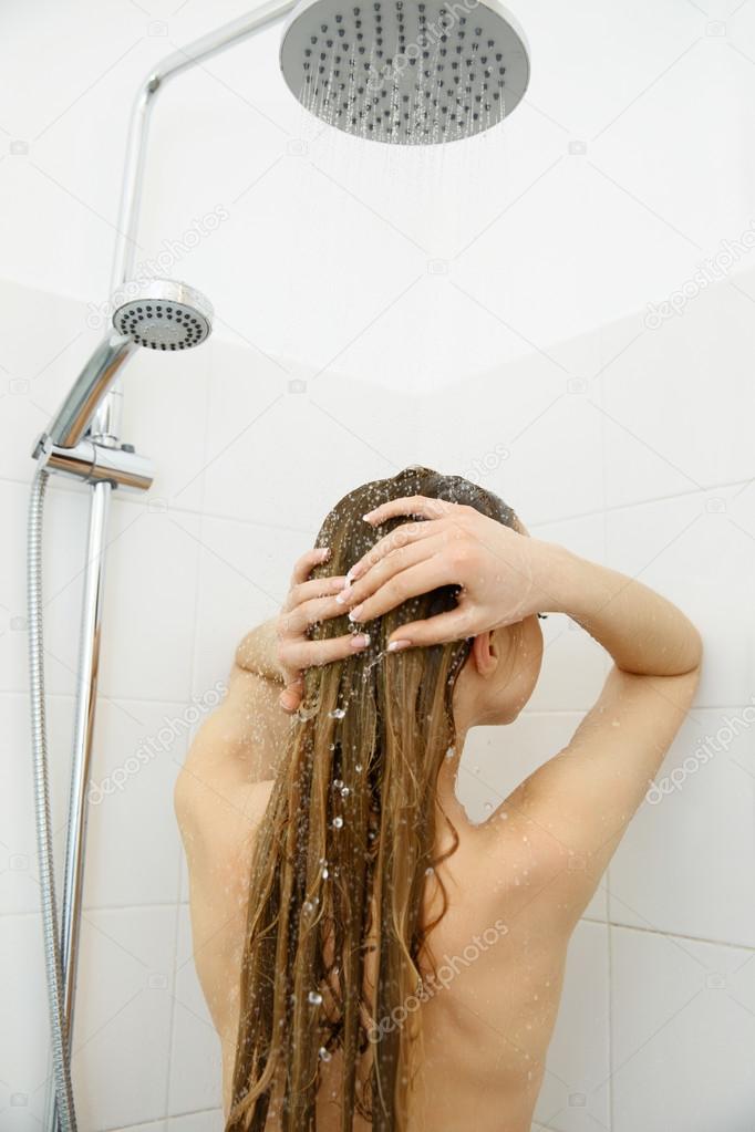 Woman in shower washing hair . Hair care