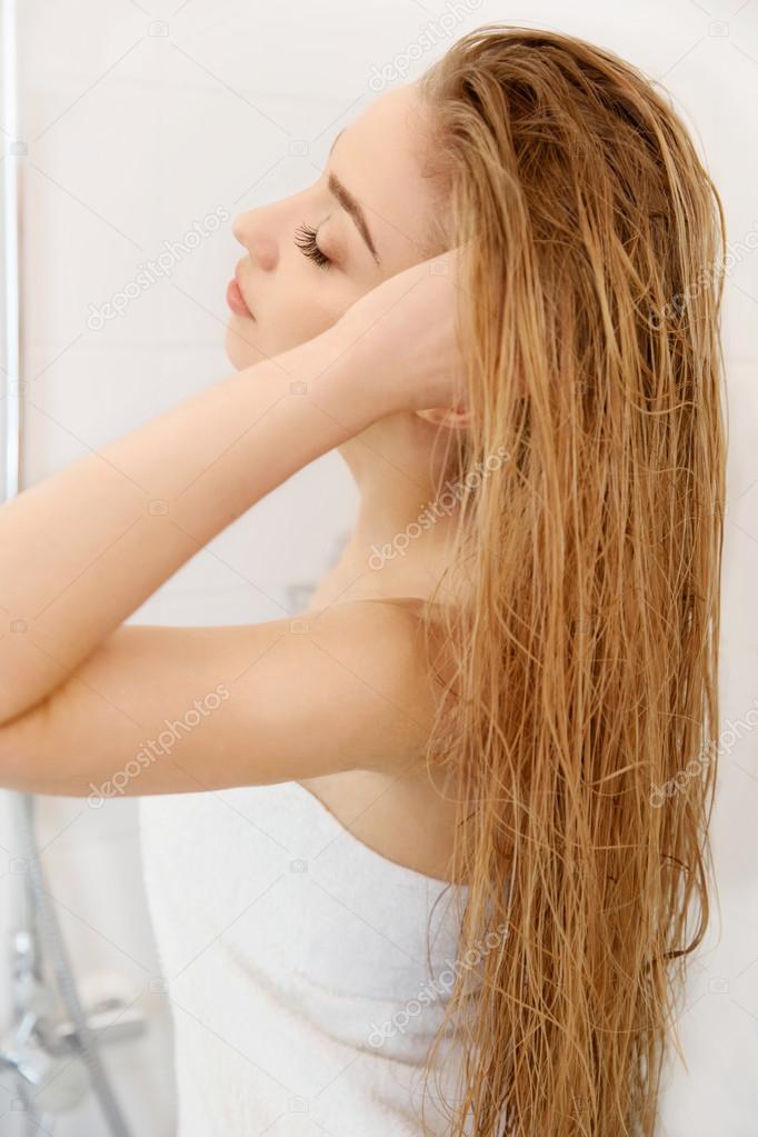 Hair. Beautiful Blond Brushing Her Wet Hair. Hair Care. Spa Beau
