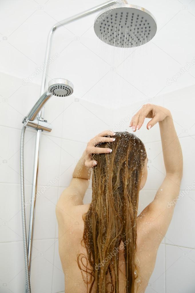 Woman in shower washing hair . Hair care