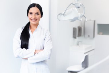 Dentist Portrait. Woman Smiling at her Workplace. Dental Clinic clipart