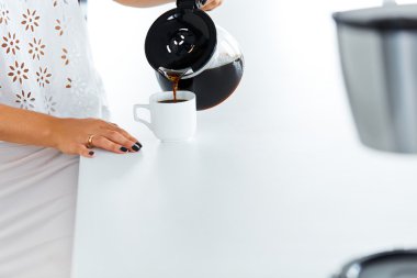 Pouring coffee to a coffee cup