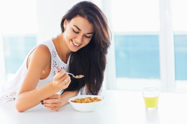 Healthy breakfast. Woman smiling and enjoying morning