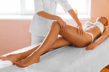 Woman legs. Body care. Girl getting leg massage treatment in spa