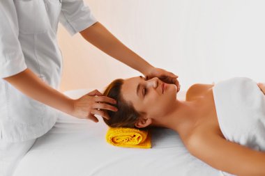 Face skin. Woman receiving facial spa treatment, massage. clipart