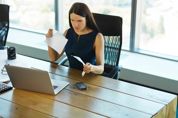 Portrait d'une femme d'affaires confus qui travaille avec des papiers dans — Photo