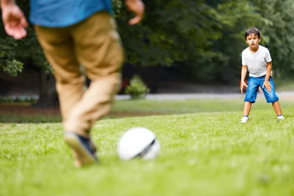 Father and son playing football in the park — Stock Photo, Image