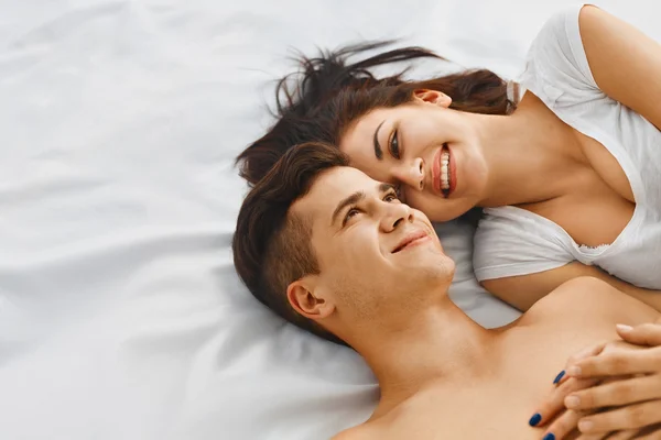 Lovely couple on bed — Stock Photo, Image