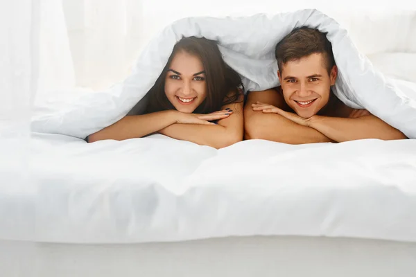 Couple in bed under the blanket — Stock Fotó