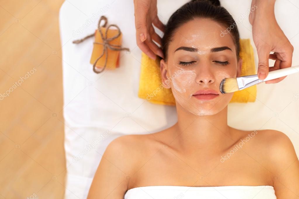 Face Treatment. Woman in Beauty Salon Gets Marine Mask