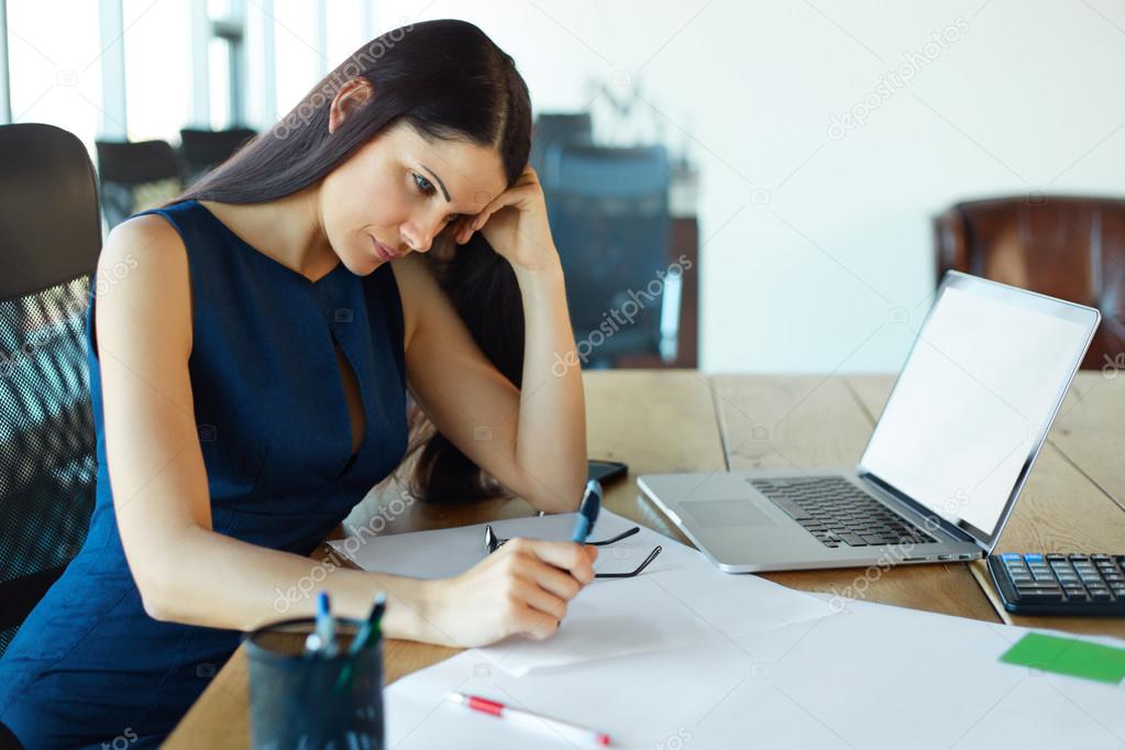 Stressed business woman at her working place. Business People