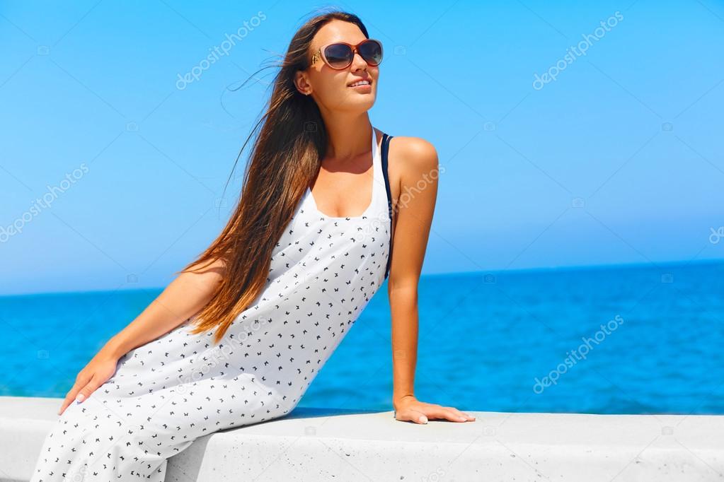 Summer vacations. Girl with long hair near the sea