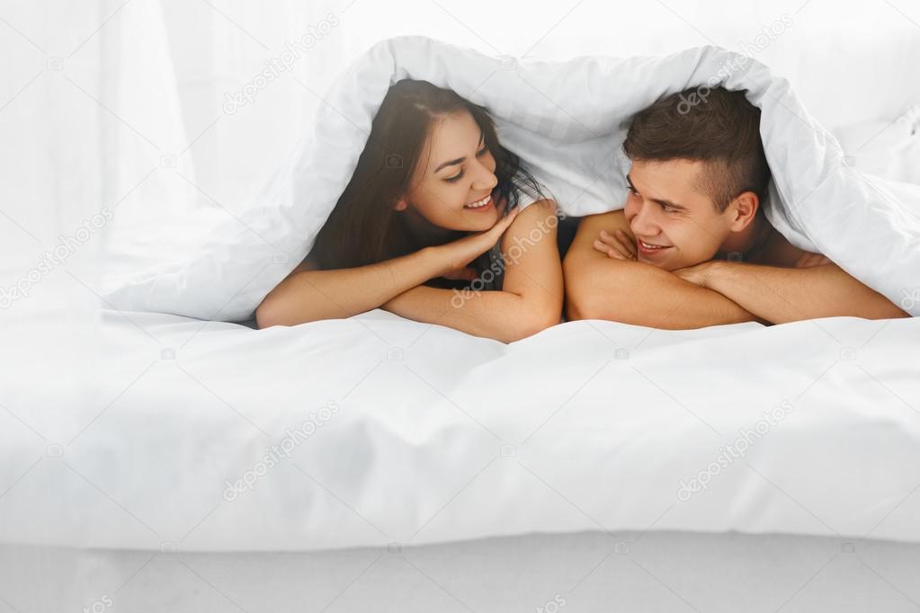 Couple in bed under the blanket