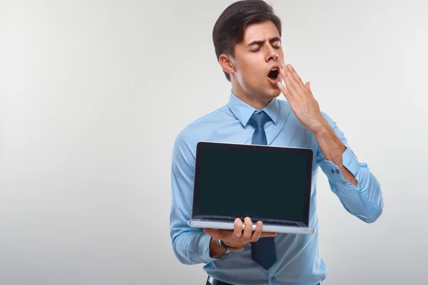 Business man holding a laptop against a white background — Stock Photo, Image