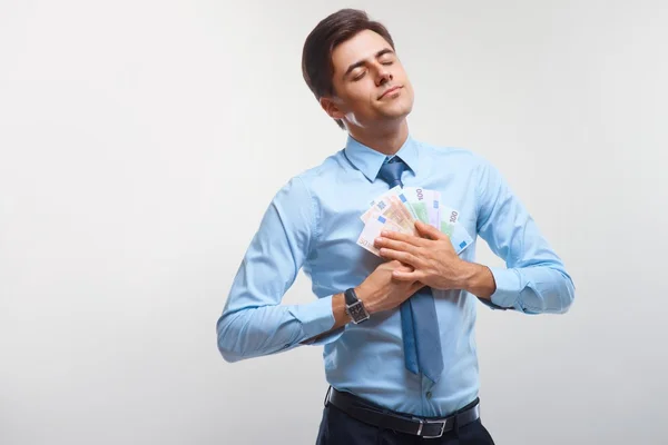 Empresario celebrando ingresos monetarios contra fondo blanco —  Fotos de Stock