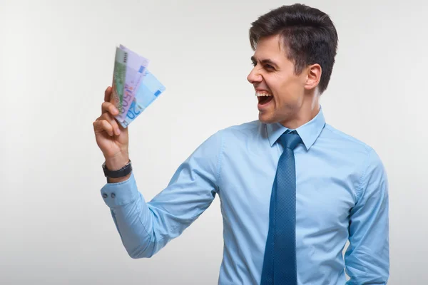 Geschäftsmann im Besitz von Geld — Stockfoto