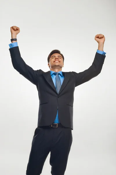 Homem de negócios comemorando o sucesso contra fundo branco — Fotografia de Stock