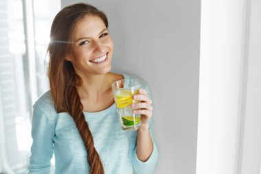 Healthy Lifestyle And Food. Woman Drinking Fruit Water. Detox. H