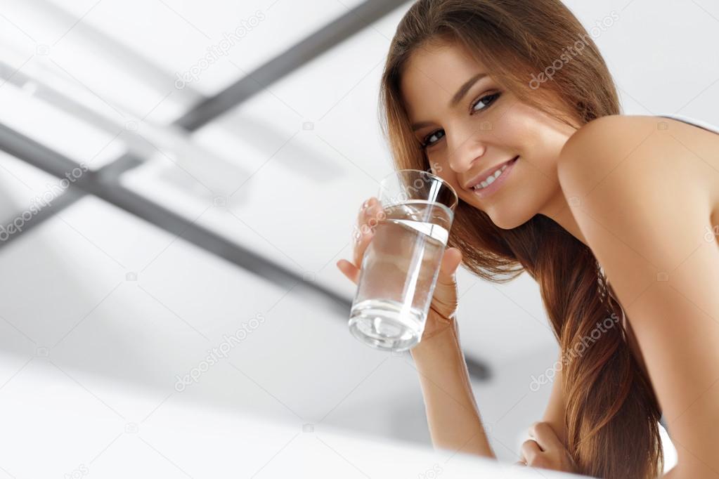 Health, Beauty, Diet Concept. Happy Woman Drinking Water. Drinks