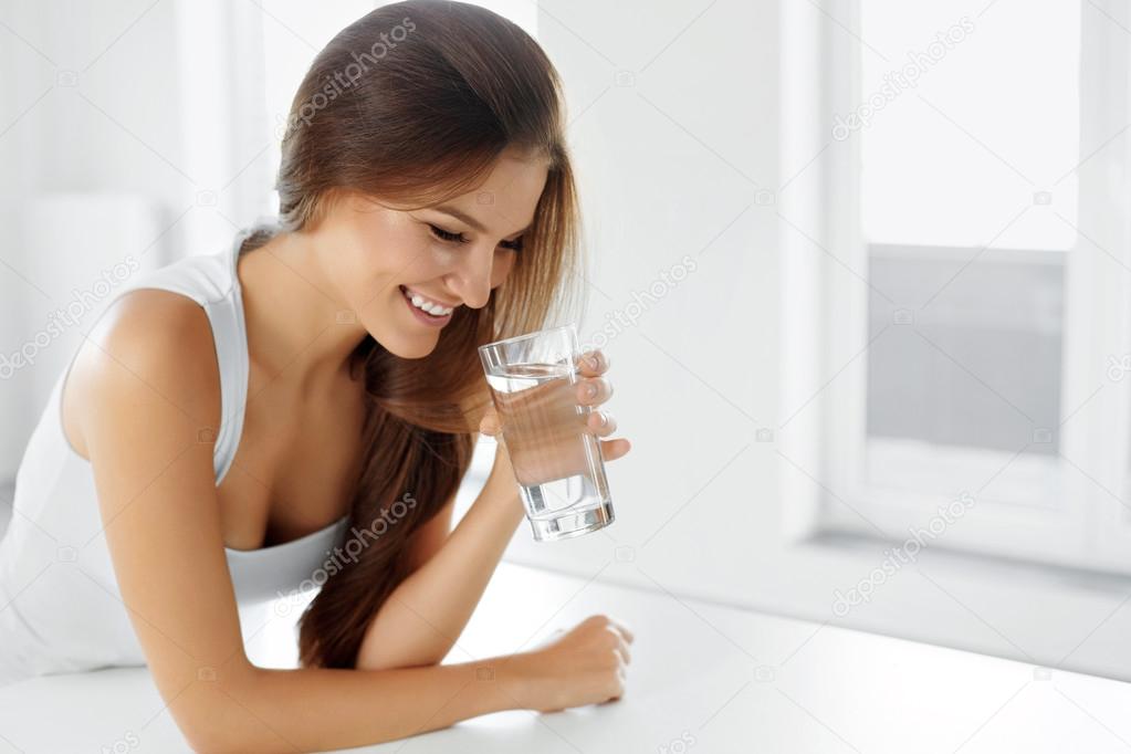 Health, Beauty, Diet Concept. Happy Woman Drinking Water. Drinks