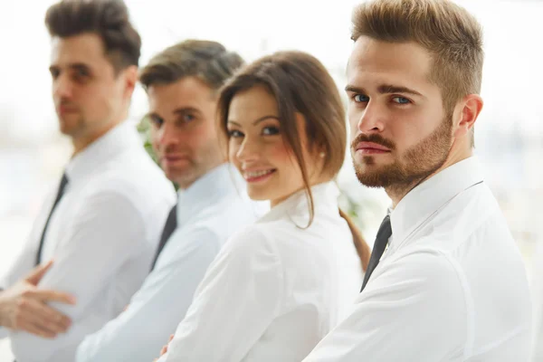 Smiling business people standing together in line in a modern of — Stock Photo, Image