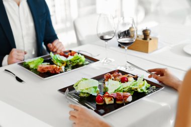 Healthy Food. Couple Eating Caesar Salad For Meal In Restaurant.