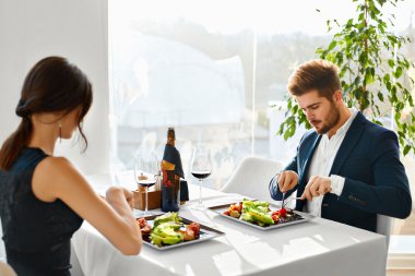 Healthy Food. Couple Eating Caesar Salad For Meal In Restaurant.
