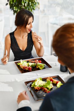 Healthy Food. Couple Eating Caesar Salad For Meal In Restaurant.