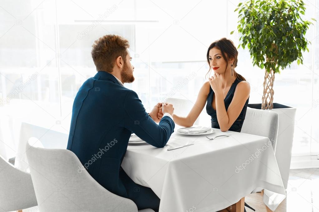 Couple In Love Celebrating. Romantic Dinner In Restaurant. Roman