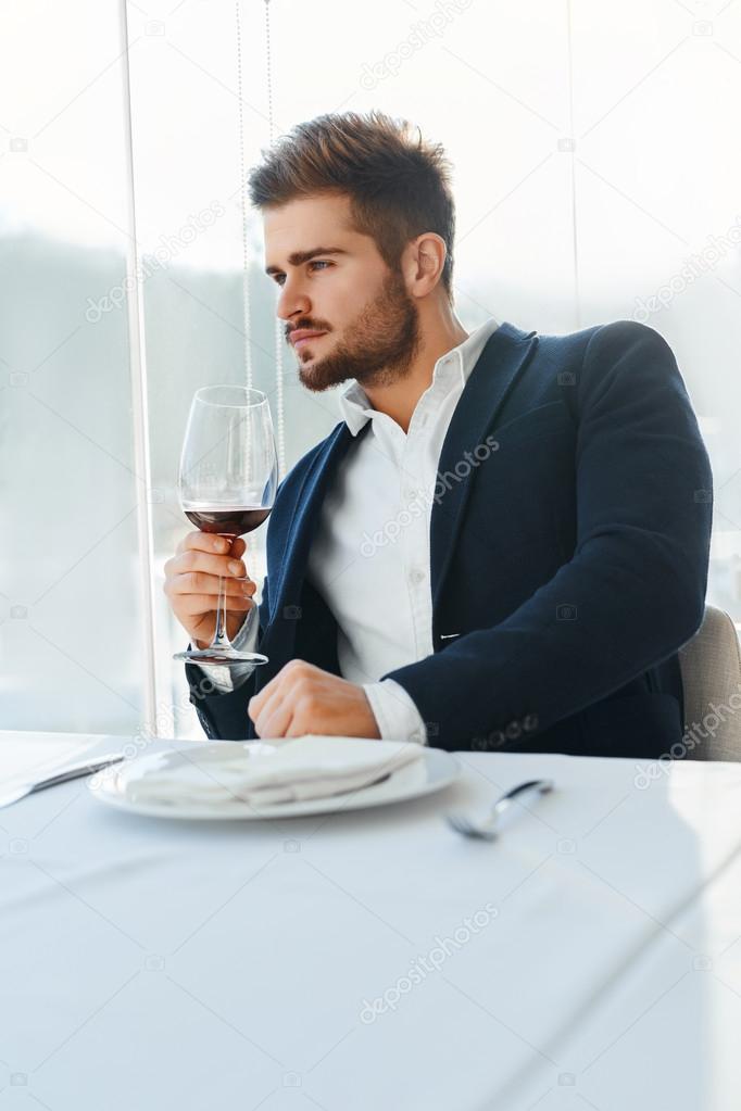 Drink. Handsome Man Drinking Wine In Restaurant. Business Man Su