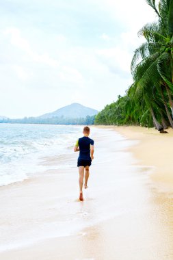 Run. Fit Athletic Man Running On Beach. Exercising. Healthy Life