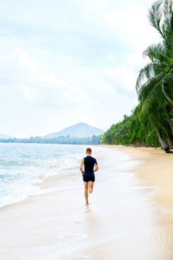 Run. Fit Athletic Man Running On Beach. Exercising. Healthy Life