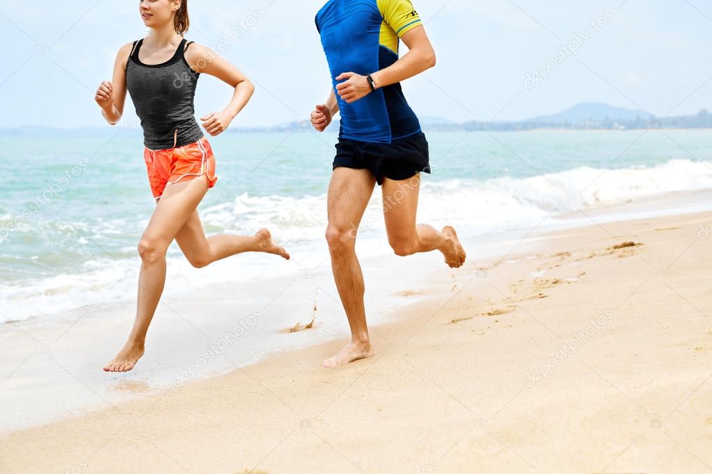 Fitness. Athletic Runners Legs Running On Beach. Exercising. Hea