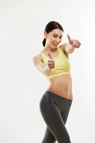 Mujer joven mostrando pulgares hacia arriba. —  Fotos de Stock