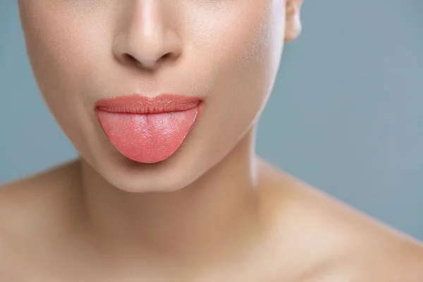 Cheerful girl showing tongue — Stock Photo, Image