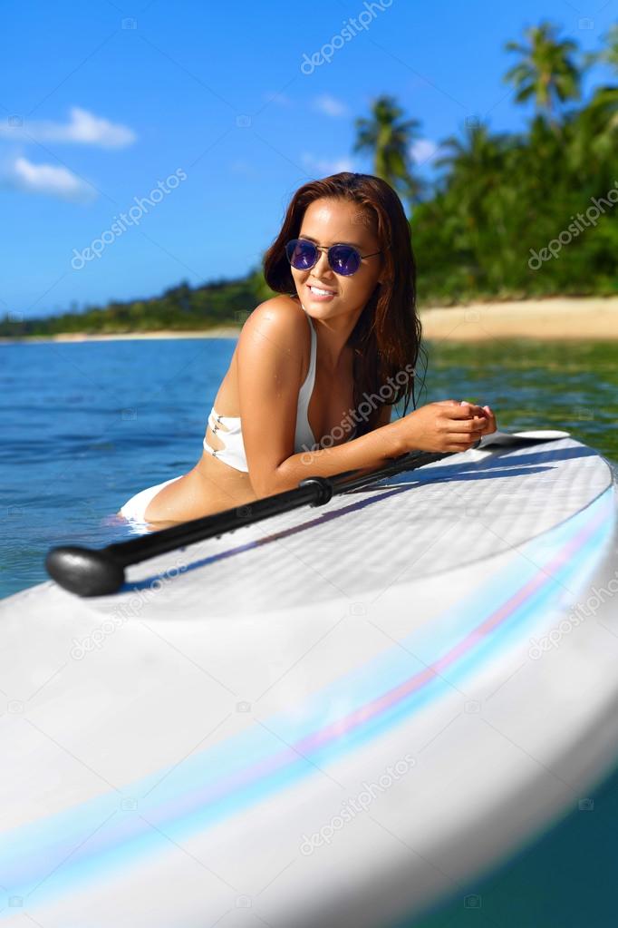 Summer Holidays. Woman On Surfing Board. Travel Vacation. Health
