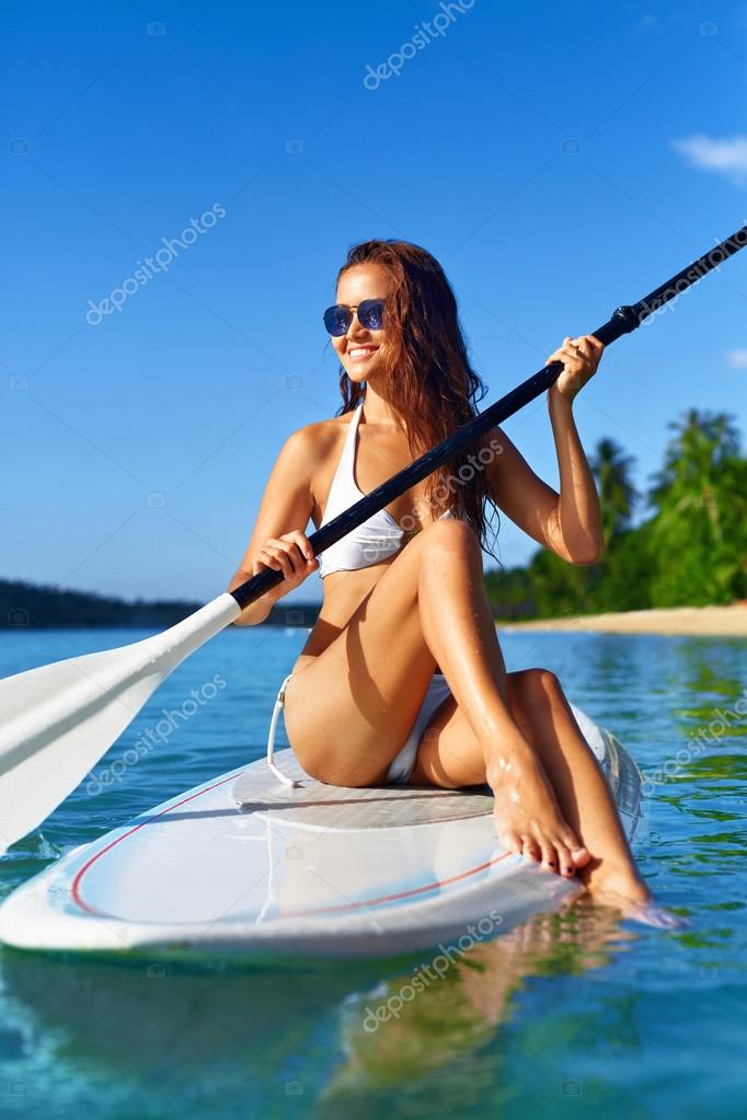 Recreational Sports. Woman Stand Up Paddle Boarding ( Surfing