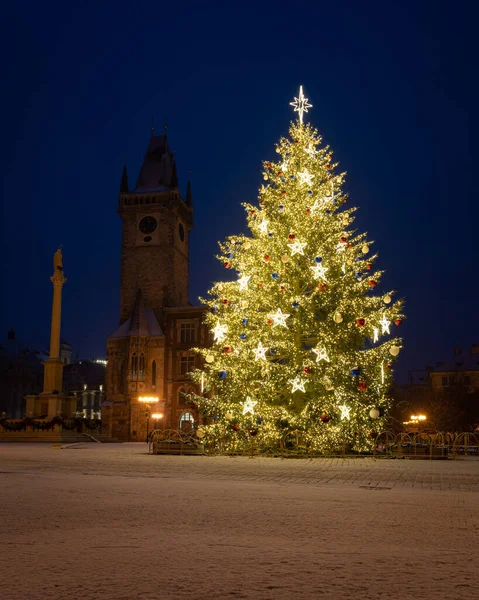 Christmas tree and the Old Town Square in Prague, Czech Rpublic, covered by fresh snow. No Christmas markets organized in 2020 due to Covid-19