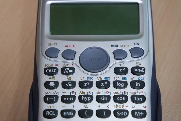 Calculator Met Gekleurde Toetsen Knoppen Geïsoleerd Een Houten Achtergrond — Stockfoto