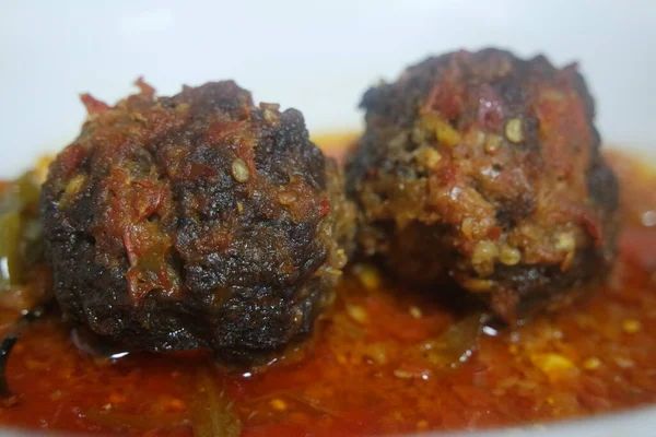 Closeup view with selective focus of meatball dish.Top view of meat balls or meat kofta curry in masala gravy in a ceramic plate.