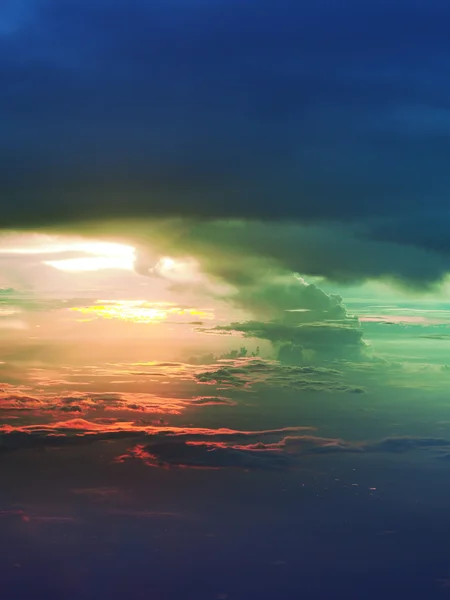 Sunset above clouds from airplane window — Stock Photo, Image