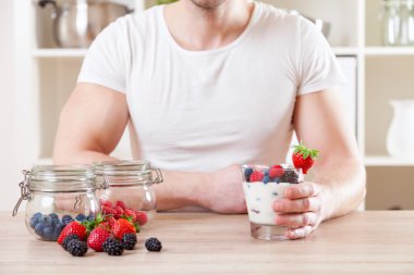 Adam taze çilek ile lezzetli yoğurt ile