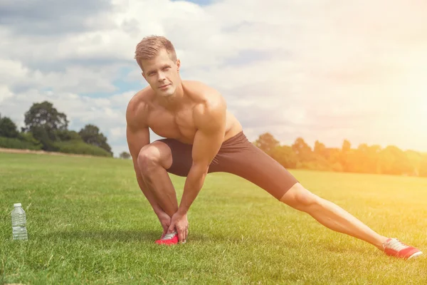 Strething out muscles before exercise — Stock Photo, Image