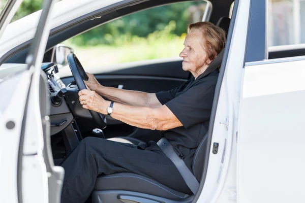 Elderly woman behind the steering wheel — Stock Photo, Image