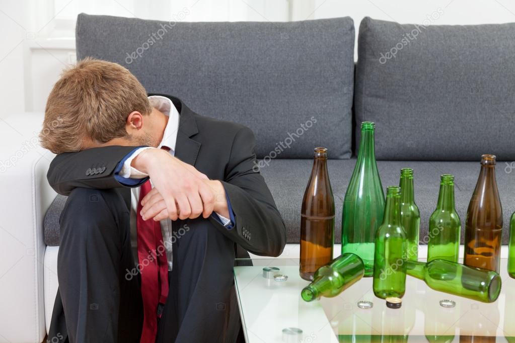Depressed businessman drunk at home 