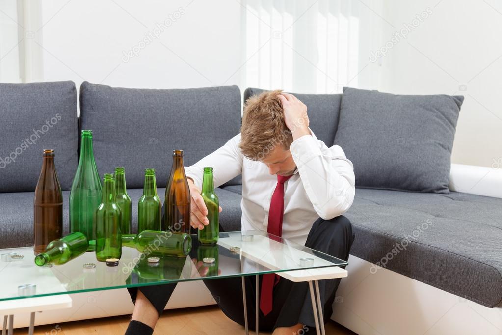 Depressed businessman drunk at home 